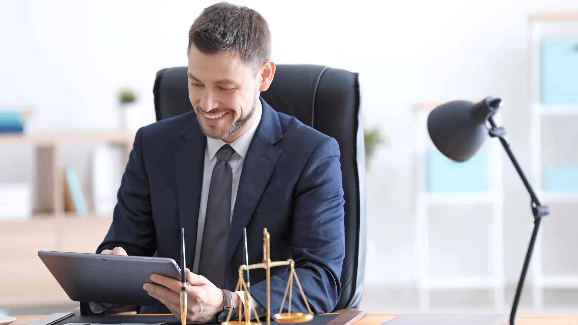 Lawyer signing legal documents at a desk with a gavel
